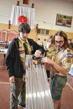 PD1 From left, Boy Scouts Steven Igielski, Griffin Kleinfelder and Colin Tornow check the racetrack at the Pinewood Derby on Sunday, Jan. 12 in the gym at Our Lady Queen of Peace Church in Hewitt. (Photo by Rich Adamonis)