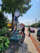 The Greenwood Lake Lions Club hard at work restoring the 30-year-old clock.