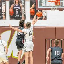 Early in the second half of the Passaic County Tournament quarterfinal game Saturday, Feb. 15, West Milford’s Ognjen Ljusic blocks the shot of Brooklyn Jelinsky. Wayne Hills won, 63-39. The girls team also lost in the PCT quarterfinal round to Passaic Tech, 56-48. (Photo by Glenn Clark)