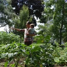 Christina Stephens of Vernon Valley Farms, with her helper Theo, shows her “miracle garden” to attendees at last year’s Kitchen Garden Tour. Her veggie patch was voted as one of the best gardens. Stephens will open her gates up to ticketholders again this year at the Kitchen Garden Tour on Sunday, Aug. 13. Tickets are available at kitchengardentours.com