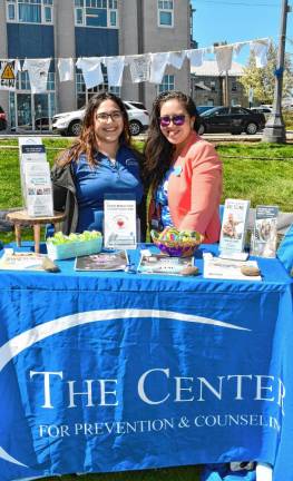 Representatives of the Center for Prevention &amp; Counseling in Newton provide information at the event.