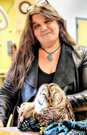 Nancy Warner, president and medical director of the Last Resort Wildlife Refuge in West Milford, tends to an owl.