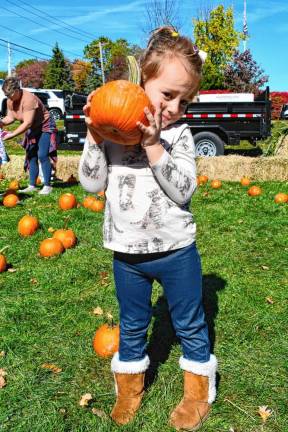 Valencia Degirolamo of Wanaque holds a pumpkin from the patch.