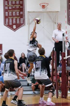 VB6 Kyle Arciniega makes an open-handed hit back over the net against Summit.