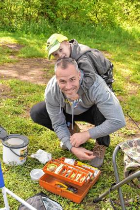 Anthony Mulan gets ready for fishing as his son Hank supervises.