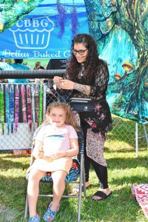 <b>Sadie Colbath has her hair done at the festival, sponsored by the Stanhope Home &amp; School Association.</b>