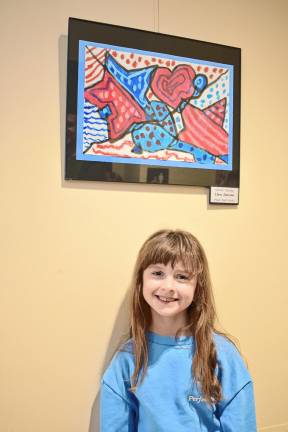 Clara Jansson, a first-grader at Maple Road school, with her ‘Patriotic Painting.’