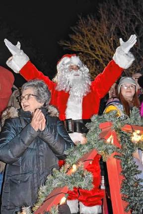 Santa signals for the Christmas tree to be lit.