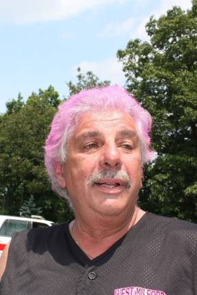 Pretty in pink, West Milford Elk's Exalted Ruler, Jim Lupo, arrives for his buzz cut. He's quite fond of his hair, he said, but let his friends add a little color to the day before his mane was sheared. Lupo brought with him a check for $5,300. raised by the Elks and The Huntsman restaurant in West Milford to add to the St. Baldrick's fund. Photo by Ginny Raue
