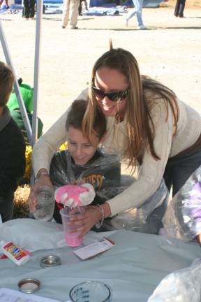 Debbie Foxen and her son Tyler play with some goo at the activity tent. For more photos, go to westmilfordmessenger.com.