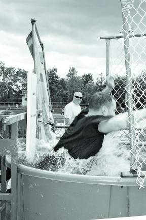 West Milford High School principal, Paul Gorski, is all wet inside the dunk tank. Photo by Ginny Raue