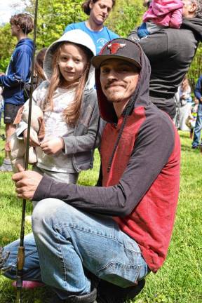 Emilia Olejnik with her father, Joel, shows off her prize, a new fishing pole.