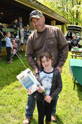 Greg Visser with his daughter Adella, who won a fishing pole at the Trout Fishing Derby.