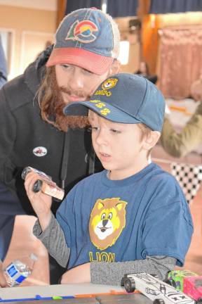 PD3 Brad Stolworthy and his son Roland inspect Roland’s car.