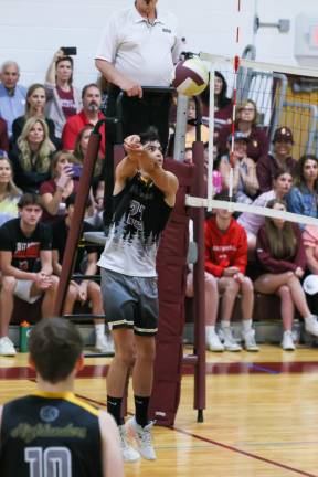 Kyle Arciniega hits a free ball back over the net during play in game 2.