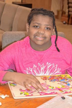 A camper works on a puzzle during Jill’s House Weekend Adventure. (Photo by Rich Adamonis)