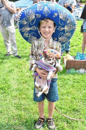 Owners and their dogs compete in a costume contest.