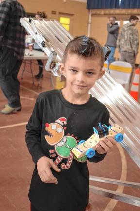 PD4 Cub Scout Dillon Bozzetti shows off his Pinewood Derby race car.