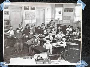 Verina Mathews Genader, who received her K-8 education at the one-room Echo Lake School before a second room was added, became a teacher there. She is seated in the back of the primary-grade classroom with first-, second- and third-graders in 1949. (Photo provided)