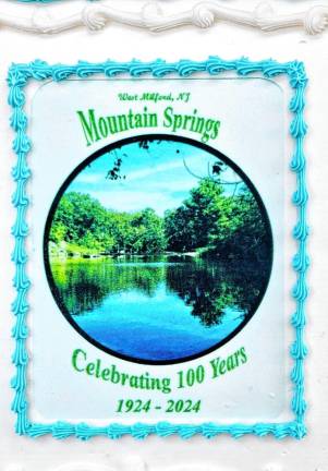 A cake with a photo of the lake celebrates the centennial of the Mountain Springs community in West Milford.