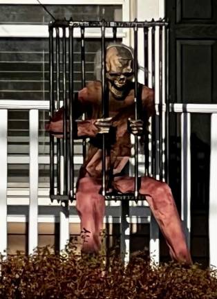 <b>A caged skeleton in red awaits at a house on Scotchtown Ave., Goshen, NY. (Photo by Beth Quinn)</b>