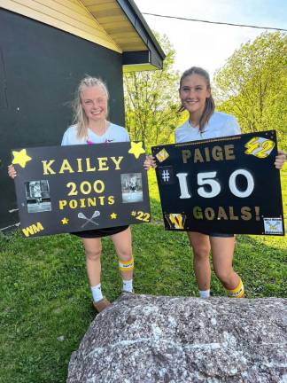 Kailey Maskerines, left, and Paige Fava celebrate milestones at the Passaic County Tournament girls lacrosse semifinal game Wednesday, May 8. (Photo provided)