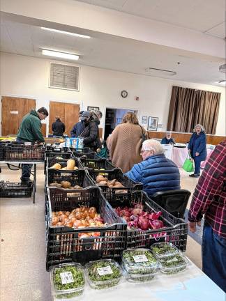 For sale at the market are produce such as hothouse lettuce and celery, root vegetables, meats, milk and eggs.