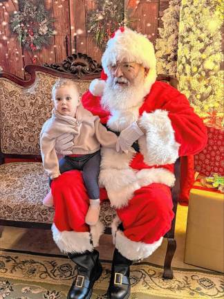 Cecilia Willever, 10 months, sits on Santa’s knee.