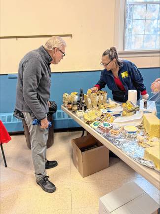 Roger Johnson of Ringwood looks at the cheeses for sale.