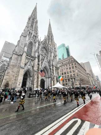 The Pipes &amp; Drums of the West Milford Highlander Band march past St. Patrick’s Cathedral on Monday, March 17 in New York City. (Photos provided)