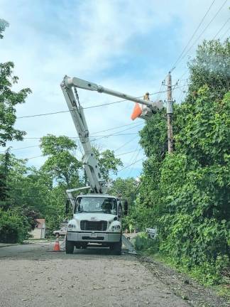 Workers restore power on Lake Park Terrace in Hewitt on Thursday afternoon, May 23. (Photo by Kathy Shwiff)