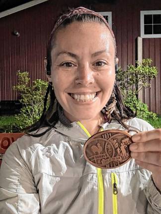 Renee Allegra of Hewitt holds the gold belt buckle that she received after running 101 miles in 36 hours in May. (Photos provided)