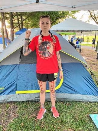 During a 24-hour ultramarathon, Renee Allegra wears feathers in her hair to honor her Native American heritage and to bring awareness to missing and murdered indigenous women.