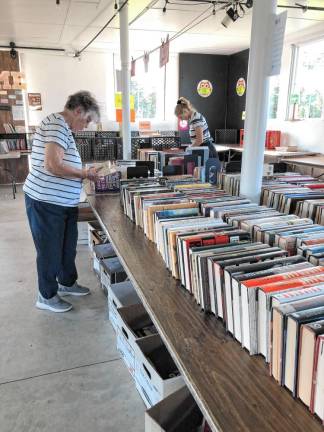 Members of the Friends of the West Milford Township Library sort donated books in the barn.