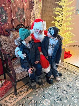 Santa talks to children at the Wallisch Homestead. The homestead’s first Christmas Market was attended by about 350 people Sunday, Dec. 1.