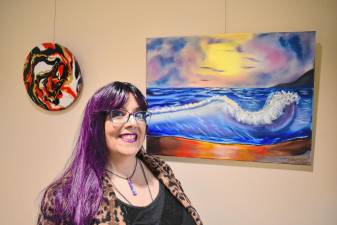 AR1 Nancy Ragusa with some of her artwork on display at the West Milford Public Library. (Photos by Rich Adamonis)