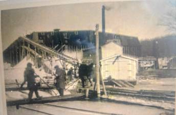 A photo taken nearly 100 years ago at the Mountain Ice Co. business at Greenwood Lake shows workers and a building where the ice was stored. (Photo courtesy of Ann Genader)