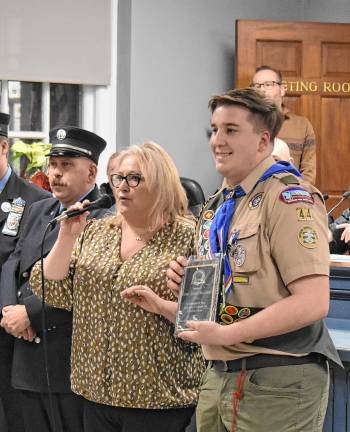 Daniel Krautheim receives a plaque for becoming an Eagle Scout.