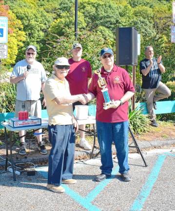 B. Fregonese accepts a trophy for Best Antique Car.