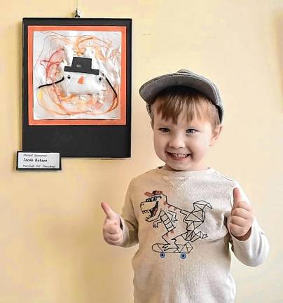 Marshall Hill preschool student Jacob Batson with his ‘Melted Snowman,’ which is on display with other student art through March at the West Milford Public Library. (Photo by Rich Adamonis)