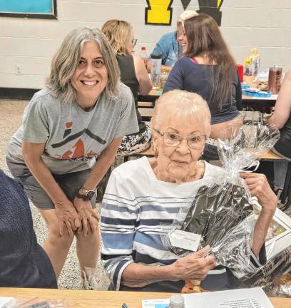 WMT2 Gladys Baker, who celebrates her 94th birthday Friday, June 28, receives one of her Tricky Tray winnings from West Milford Animal Shelter Society volunteer Jeanne Finnan, left.