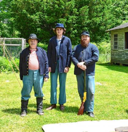 Members of the 6th New Hampshire Volunteers, a group of Civil War re-enactors, from left, are Cpl. Darryl Henkel, Pvt. Jonathan Marten and Sgt. Kristopher Brembt with his Henry repeating rifle.