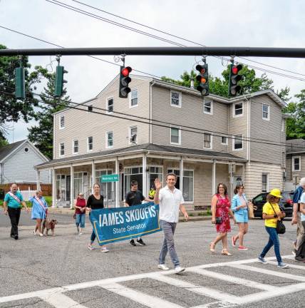 New York state Sen. James Skoufis, in white shirt, marches in the parade.