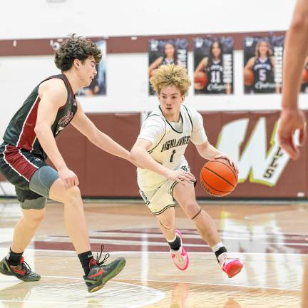 John DelVecchio of West Milford dribbles in to the lane past Brooklyn Jelinsky of Wayne Hills in the quarterfinal game of the Passaic County tournament played at Wayne Hills.