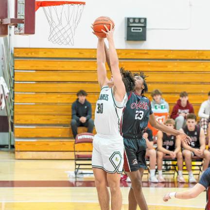 Grabbing a rebound on the defensive end is the Highlanders’ Tyler Liguori as Wayne Hills’ Chernoh St. Paul tries for the steal.