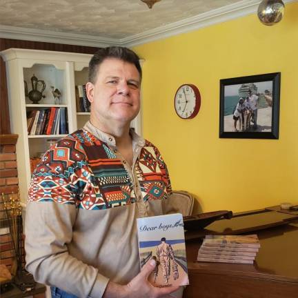 David Chamalian of West Milford holds a book that he wrote for his two sons, now in their 20s. (Photo by Rich Adamonis)