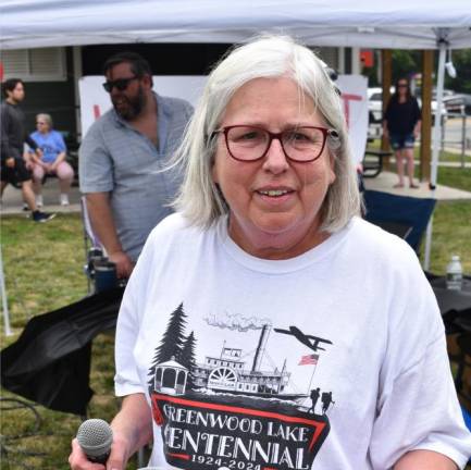 Nancy Clifford, a village trustee. holds the winning numbers in the Centennial Ball Drop fundraiser. The purchasers of the first, second and third balls that fell closest to a target won $1,500, $500 and $250, respectively.