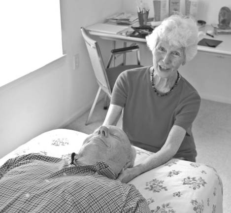 Mary Bennett, a certified massage therapist, provides cranio-sacral therapy to her husband, Bill. Bennett has a room at Chelsea at Bald Eagle where she provides her services.