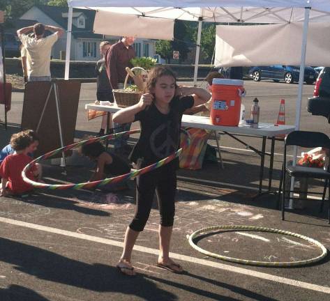 Several kids gave the hula hoop a try at the farmer's market Wednesday.