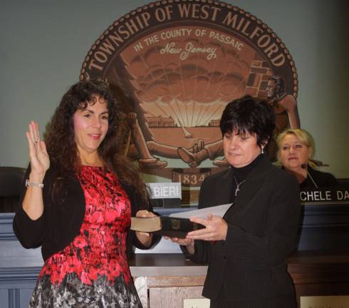 Photos by Linda Smith Hancharick Mayor Bettina Bieri took her third oath of office as mayor in the township. Township Clerk Antoinette Battaglia, right, administered the oath to her.